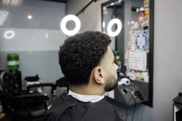 Curly hair with a taper, seen from behind in the Furious Fades shop